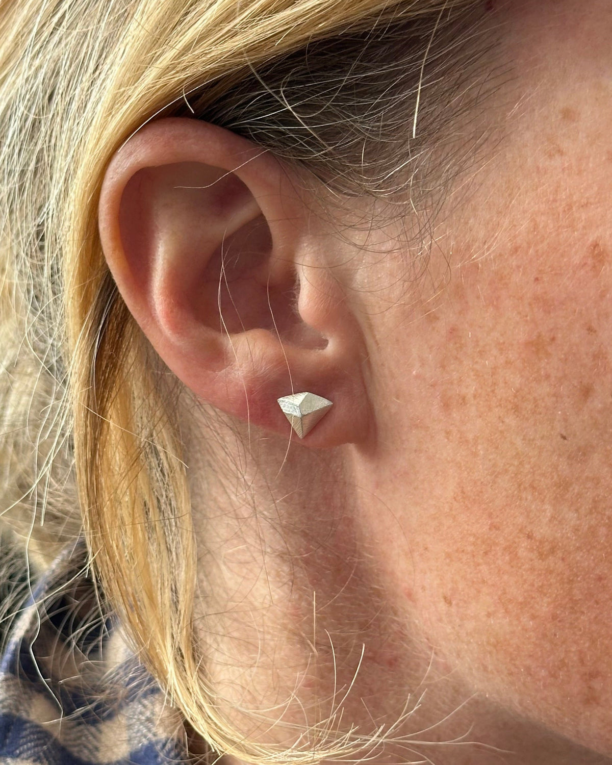 Climbing inspired earring in silver, shown on model. Designed by Hannah Weston, York.
