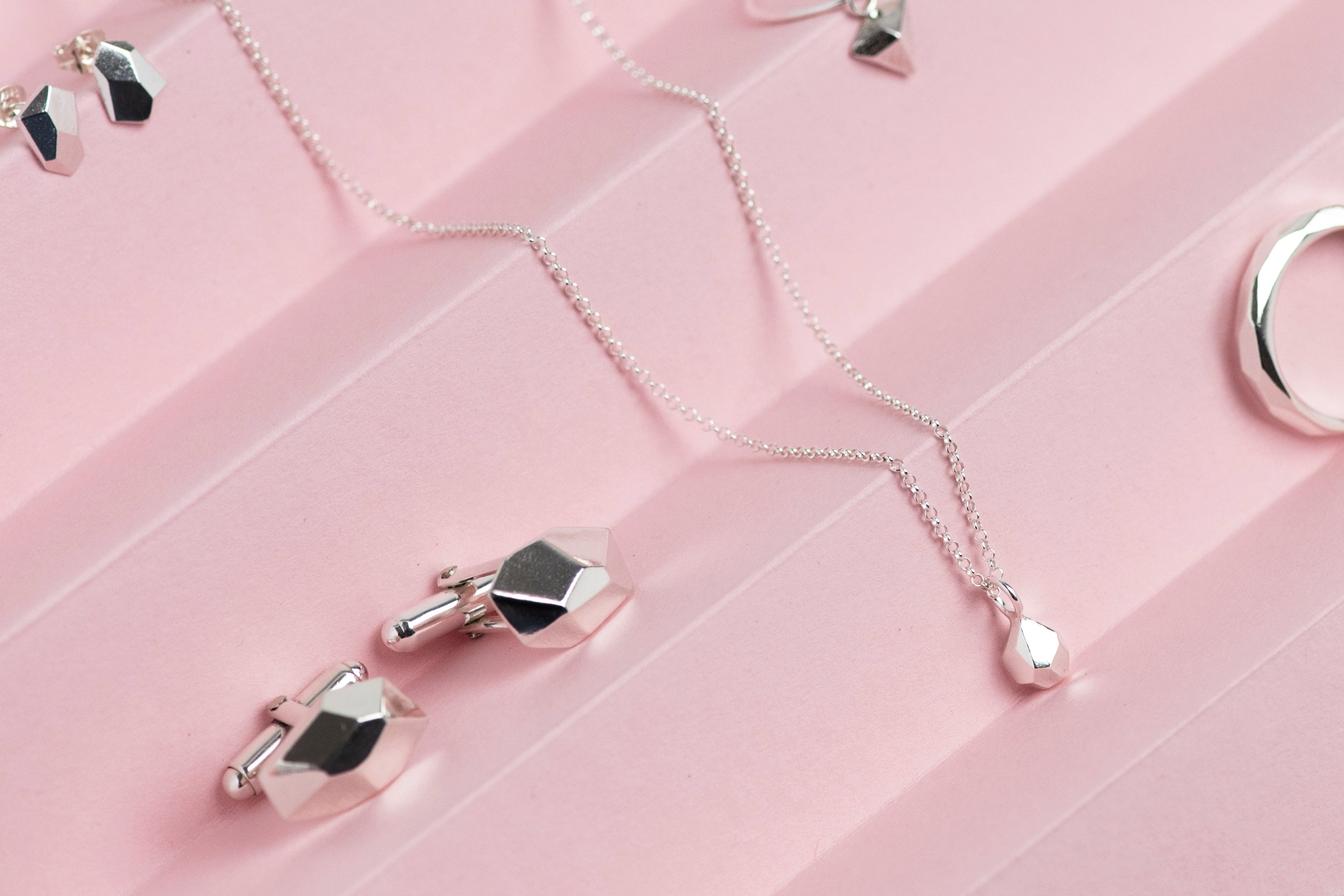 Silver geometric cufflinks, pendant , ring and earrings by Hannah Weston.