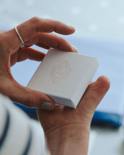 Hannah holding a white, embossed Hannah Weston Jewellery gift box.