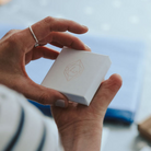 Hannah holding a white, embossed Hannah Weston Jewellery gift box.