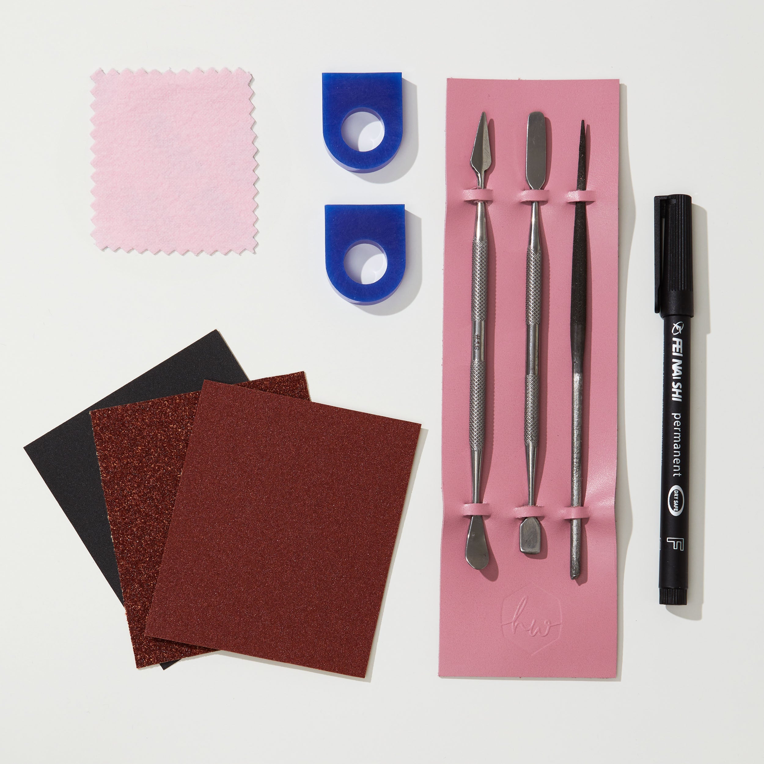 Set of tools and materials for jewelry making on a white background