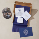 Unopened box with stationery items including cards and a card with text and logo.