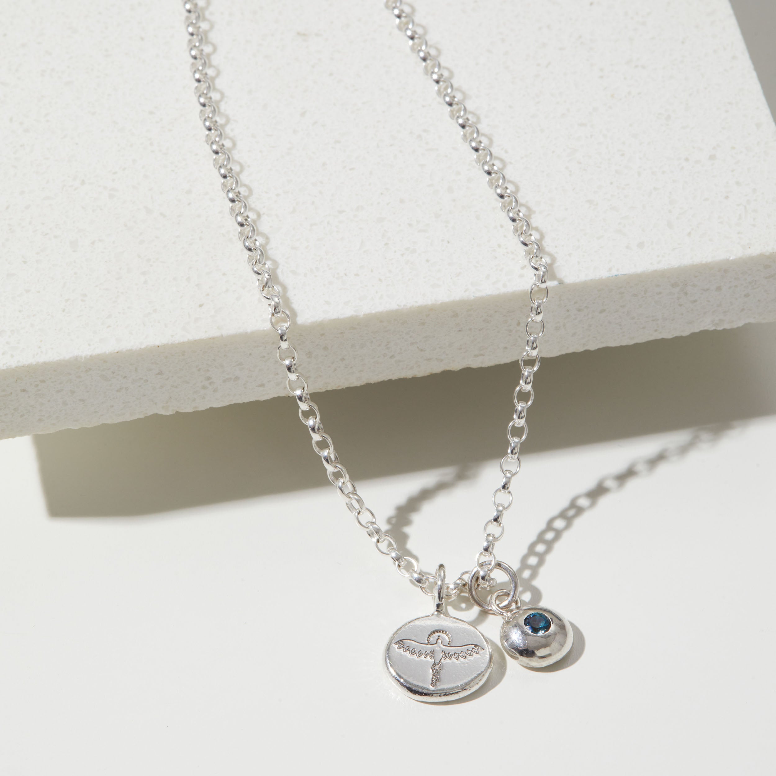 Sterling silver necklace with phoenix and birthstone charms on a white background.