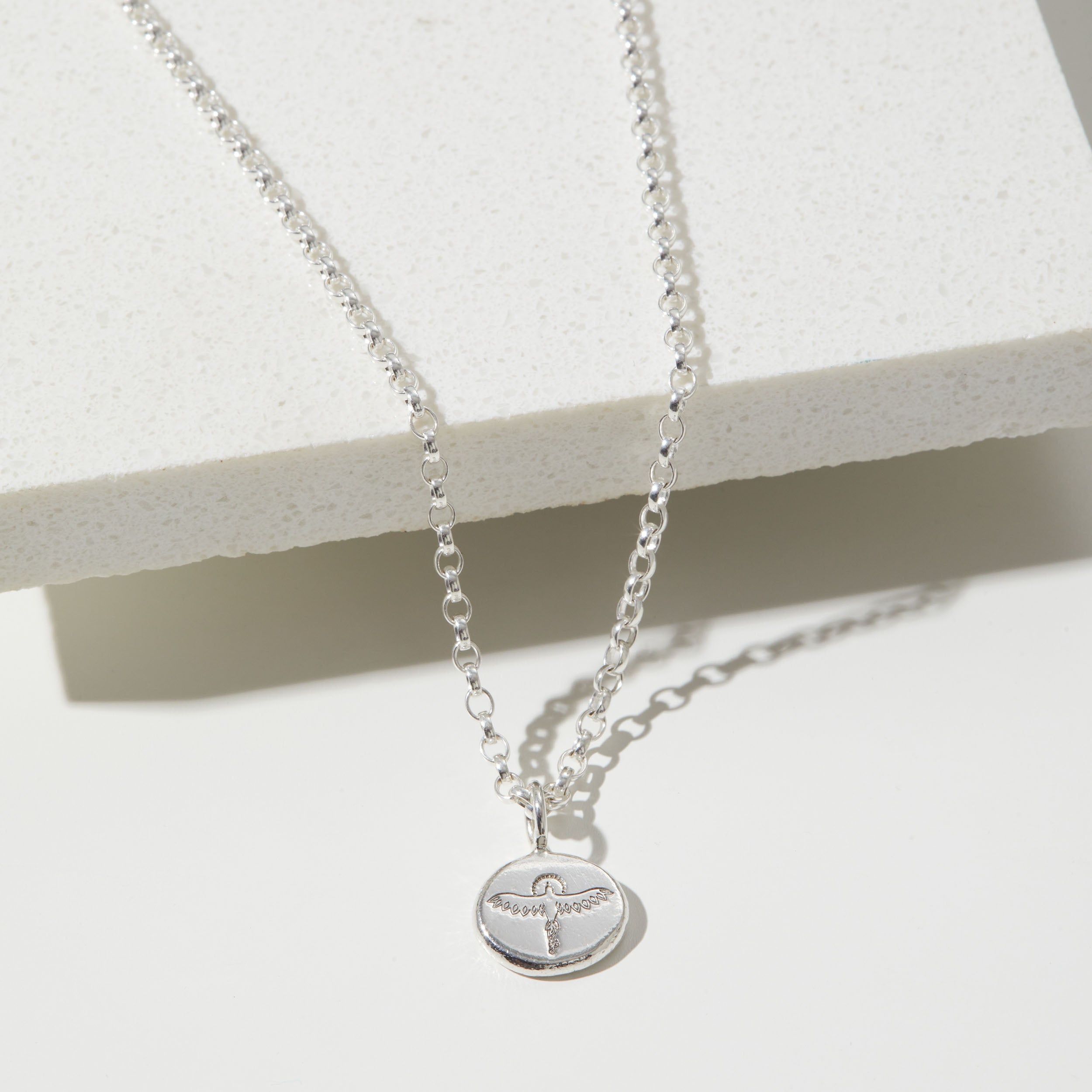 Silver phoenix necklace with a pendant on a white background