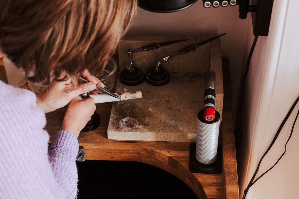 Hannah at her workbench making a ring.