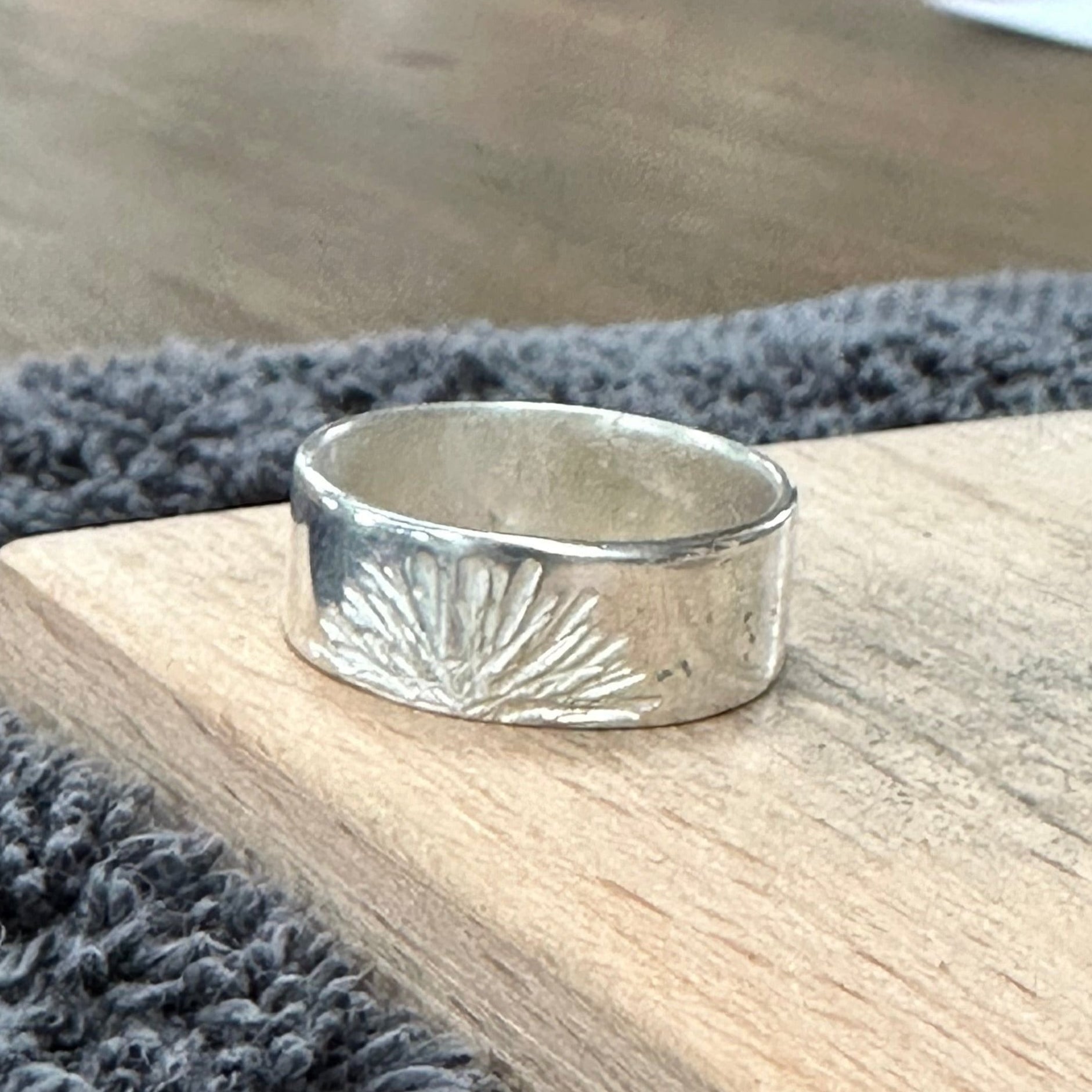 Sunburst textured silver ring made by a workshop student.