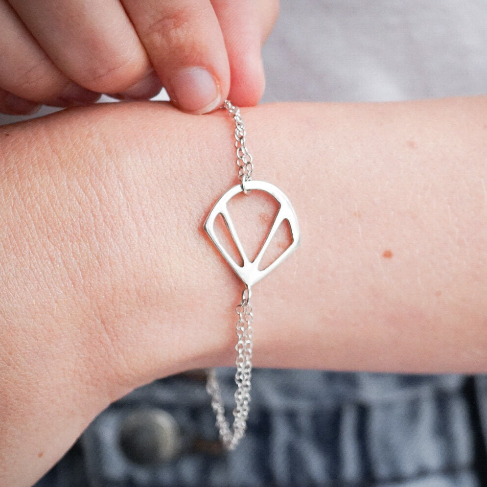 Woman wearing a sterling silver, art deco shell style bracelet.