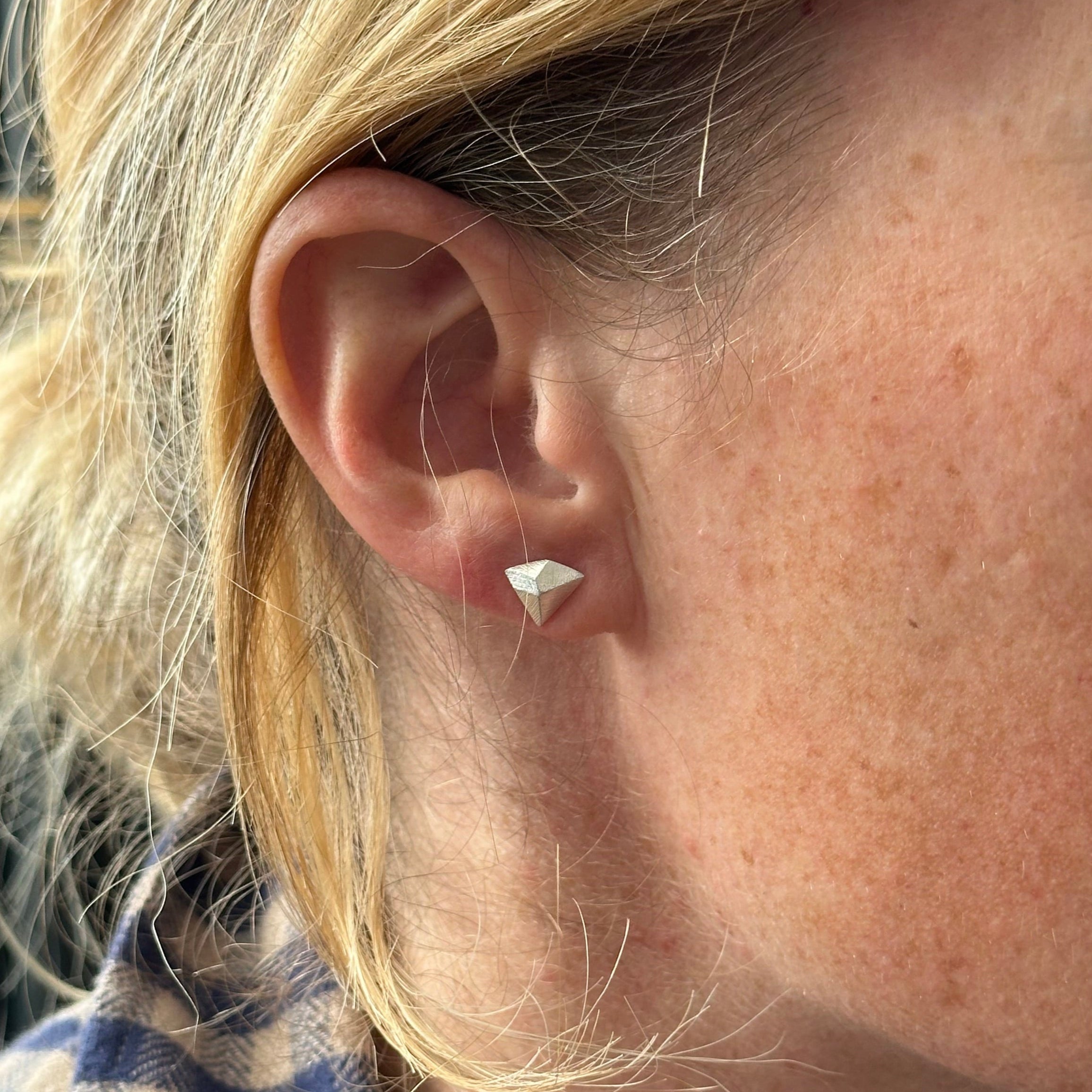 Climbing inspired earring in silver, shown on model. Designed by Hannah Weston, York.
