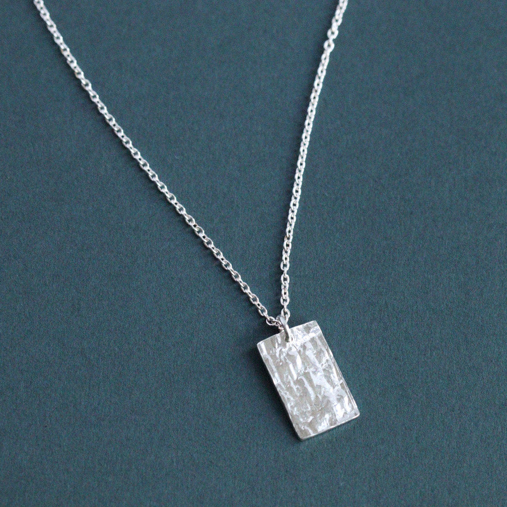 Real bark textured rectangular pendant in sterling silver. Handmade by Hannah Weston Jewellery, York.