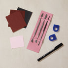 Set of ring carving tools and materials on a beige surface