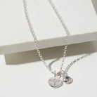 Sterling silver necklace with phoenix and birthstone charms on a white background.
