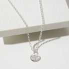Silver phoenix necklace with a pendant on a white background
