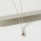 Silver birthstone pendant on a pebble chain.