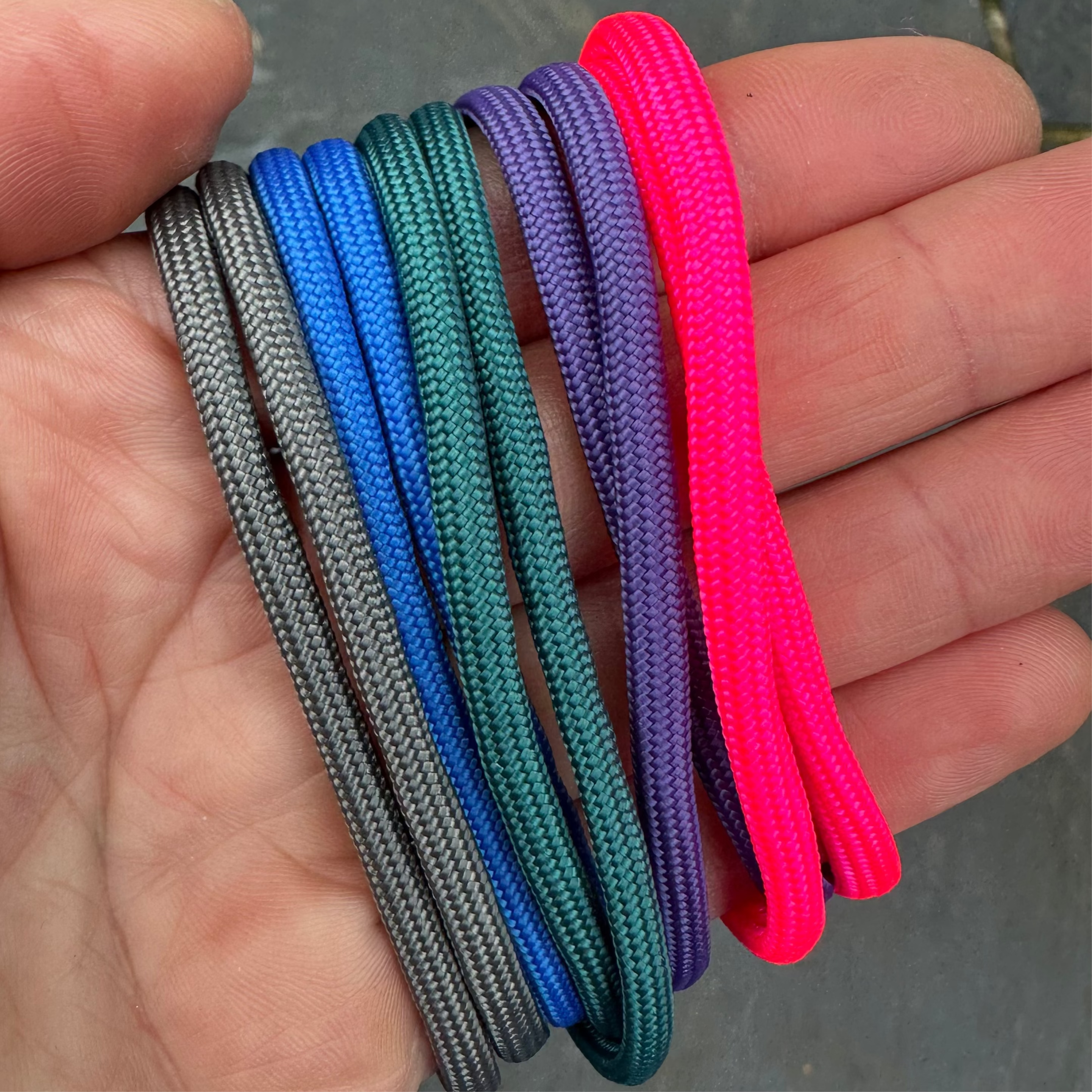 Grey, blue, dark green, purple and neon pink paracord.
