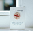 Phoenix on a pin pin badge on a white card.