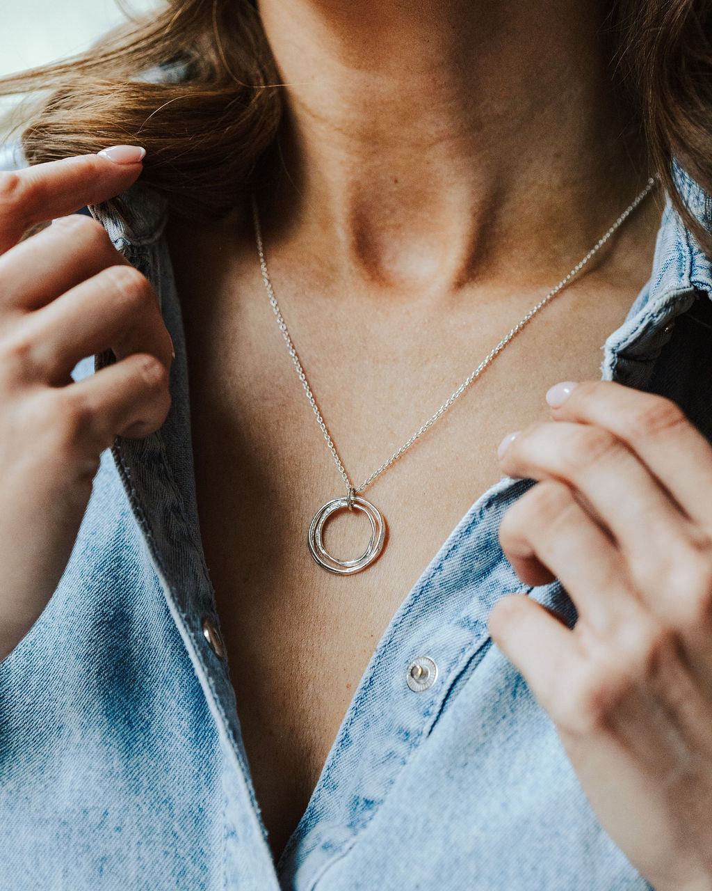 Woman in a denim shirt wearing sterling silver circles necklace