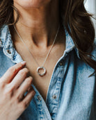 Woman in a denim shirt wearing a sterling silver circles necklace