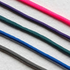 Set of colorful ropes on a textured white background