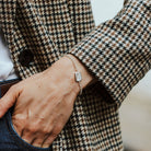 woman wearing a sterling silver bracelet with a feather motif