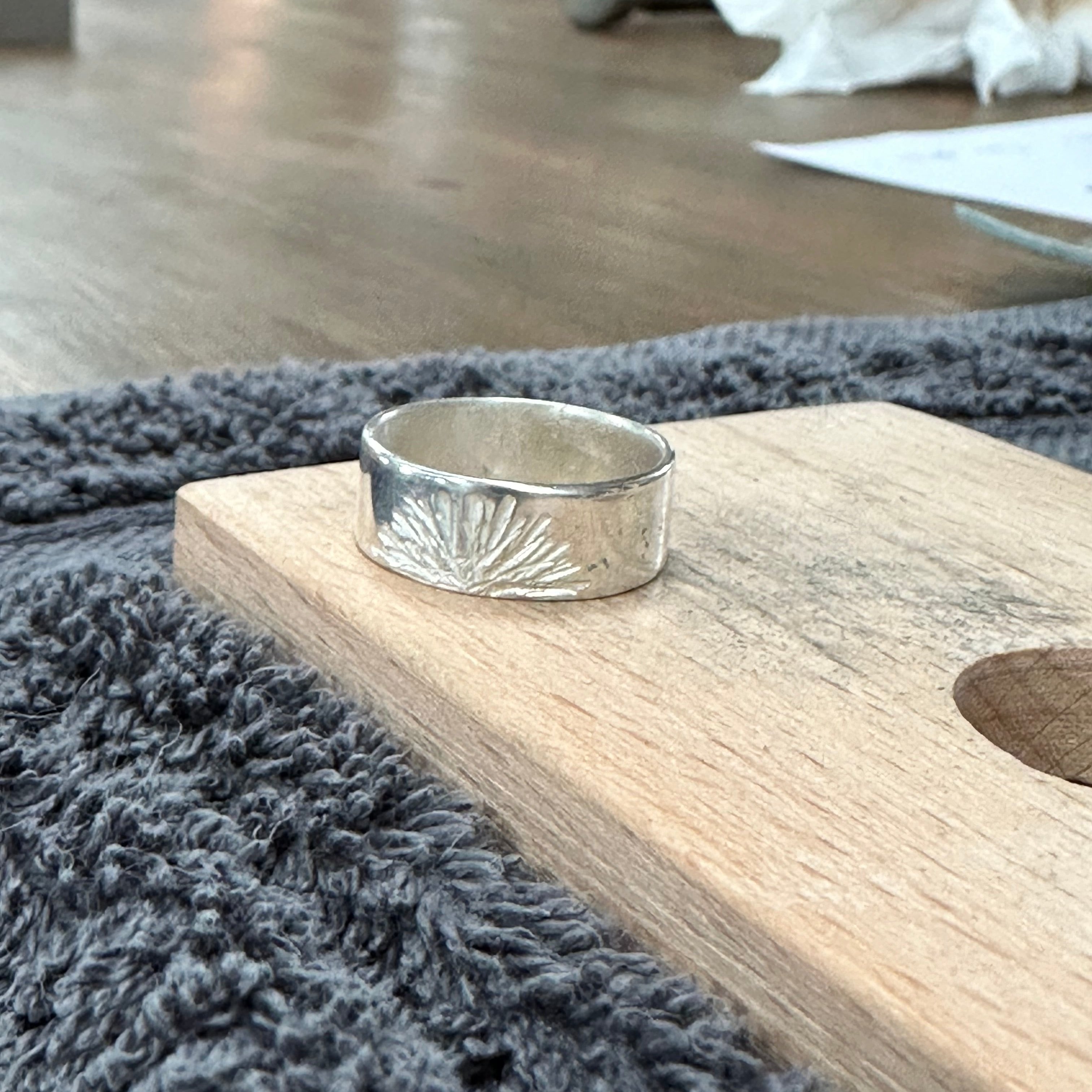 Sunburst textured silver ring made by a workshop student.